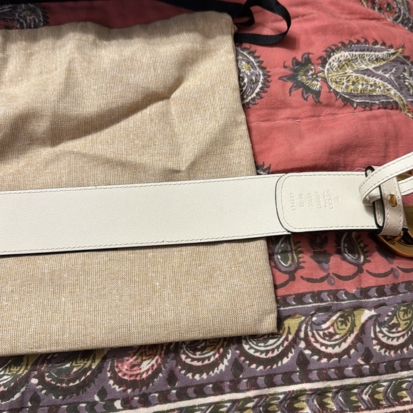 Tan gucci belt, with gold gucci sign, and black and brown gucci imprint on it. - Picture 8 of 11
